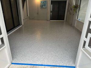 Renovated Florida room in Plantation, FL featuring sleek epoxy floor coating with glossy finish and modern upgraded patio space.