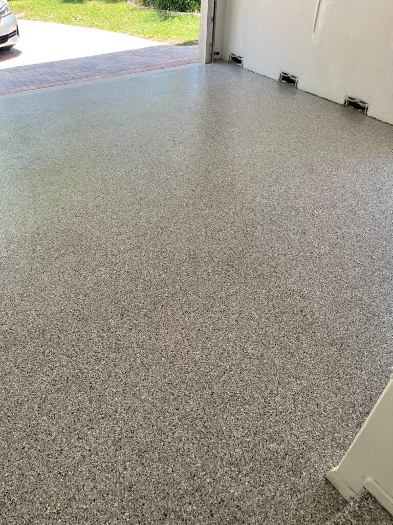 Family-Friendly Garage Epoxy Floor in Coconut Creek, FL | Coyote Flake Mix | GonzaBuilt Completed Coyote flake epoxy garage floor transformed into family play space after GonzaBuilt installation in Coconut Creek, Florida