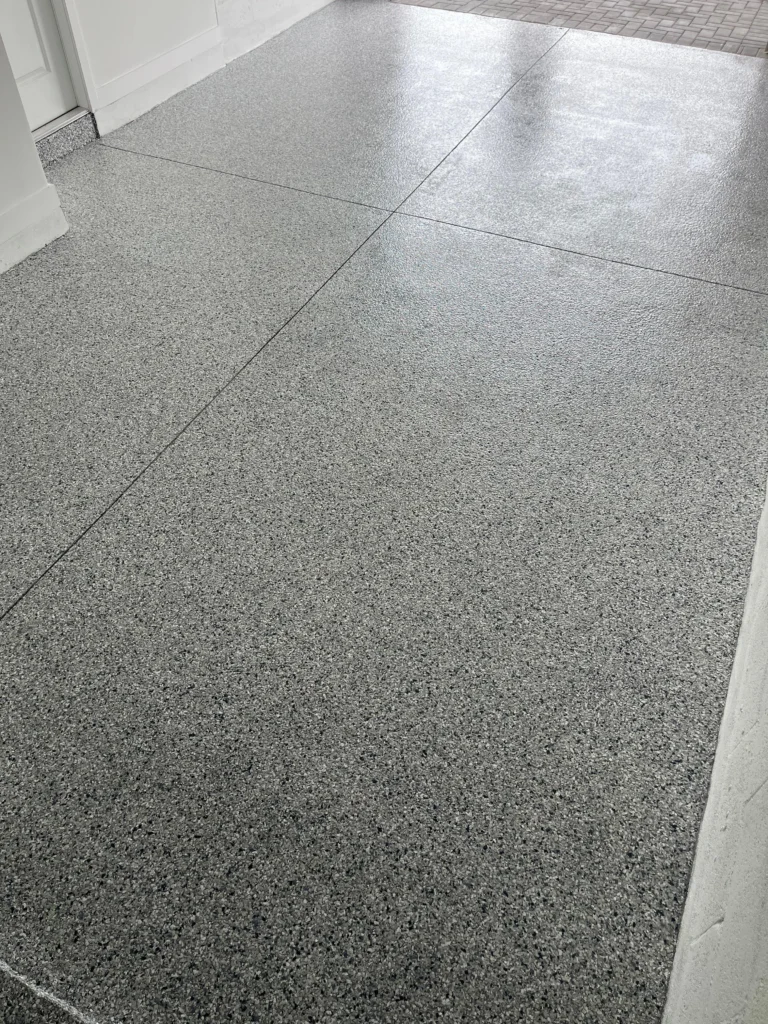 New Build Garage Epoxy Floor in Lake Worth, FL | ¼" Tidal Wave Flake | GonzaBuilt Wide view of bare new construction garage concrete floor before Tidal Wave flake epoxy coating by GonzaBuilt in Lake Worth, Florida