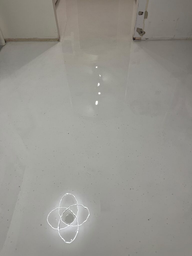 Completed glossy white terrazzo epoxy finish covering entire home interior after professional installation by GonzaBuilt in Hollywood, Florida