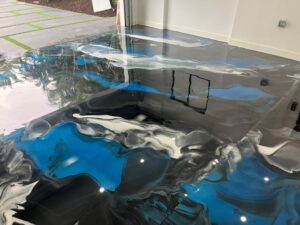 Completed custom metallic blue epoxy floor after handmade installation by GonzaBuilt at Lighthouse Point, Florida waterfront home