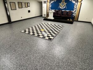 Completed Domino flake epoxy floor replacing old checkered tile in Miami lodge after professional installation by GonzaBuilt